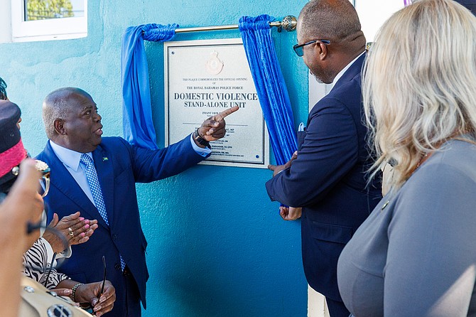 A plaque is unveiled at the opening of the domestic violence unit. 
Photo: Dante Carrer/Tribune Staff