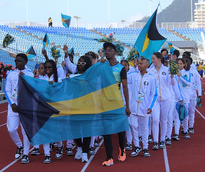 Bahamas swimming and track athletes Aryton Moncur, Mia Patton, Annae Mackey and Jehiel Smikle leading the parade into the Hasely Crawford Stadium on April 18, 2025. Photo Brent Stubbs