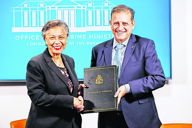 Cabinet secretary Nicole Campbell and Tribune president and Bahamas Aviation, Climate and Severe Weather Network Ltd (BACSWN) founder Robert Carron during the heads of agreement signing ceremony between the government of The Bahamas and BACSWN at the Office of The Prime Minister on May 7, 2025.  Photo: Dante Carrer/Tribune Staff