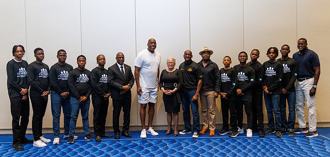 Magic Johnson poses with Minister of Education Glenys Hanna-Martin (center) and the participants of the NexGen Young Men Mentorship Programme.