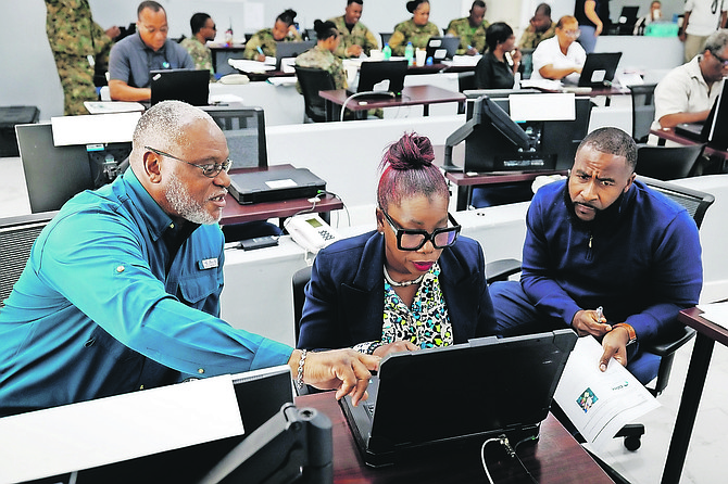 Personnel during a National Disaster Readiness Exercise at the National Emergency Operations Centre on Friday.  
Photo: Dante Carrer/Tribune Staff