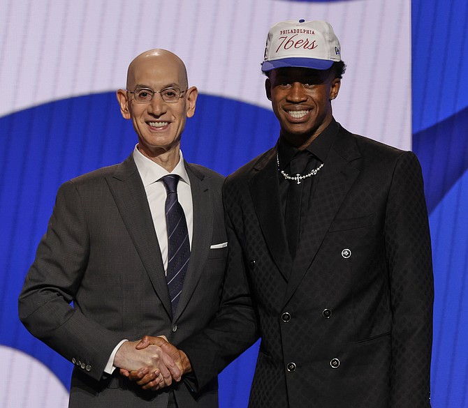 VJ Edgecombe poses for a photo with NBA commissioner Adam Silver after being selected third by the Philadelphia 76ers In the first round of the NBA basketball draft, on Wednesday in New York. Photo: Adam Hunger/AP