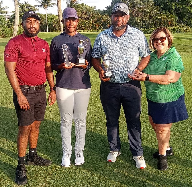 National champions Maddison Carroll and Lynford Miller receive their awards from Quentin Gibson of RF Bank and Trust, far left, and tournament director Gina Gonzalez-Rolle.