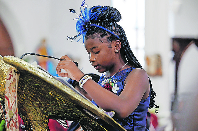 Latayah Poitier speaks during the funeral of her father Reserve Inspector Lernex Williams at Christ Church Cathedral yesterday.  
Photo: Dante Carrer/Tribune Staff