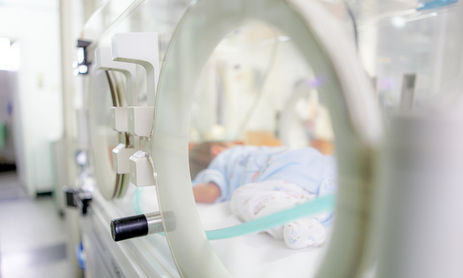 A stock image showing a baby in hospital care. A mother speaks of her ten-year battle for justice after a doctor botched the delivery of her son leaving him with lifelong debilitating disabilities.