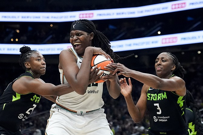 New York Liberty forward Jonquel Jones tries to hold onto the ball under pressure from Seattle Storm guard Jewell Loyd, left, and forward Nneka Ogwumike, right, during the second half of a WNBA basketball game, Aug. 30, 2024, in Seattle. (AP Photo/Lindsey Wasson, File)