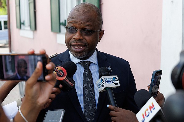 Minister of National Security Wayne Munroe KC speaks to reporters outside the House of Assembly on July 30, 2025. Photo: Dante Carrer/Tribune Staff
