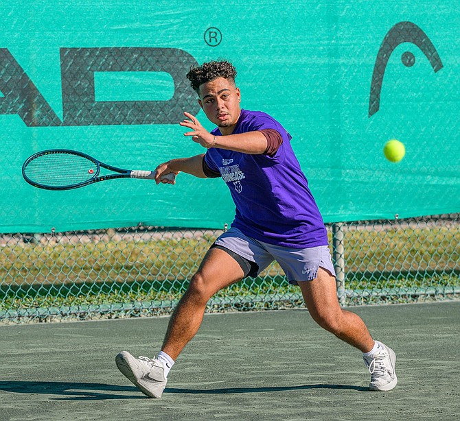 Tennis phenom Khai Rees with one of his many trophies.