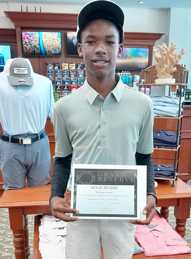 Rashawn Hanna proudly holds his hole-in-one certificate.