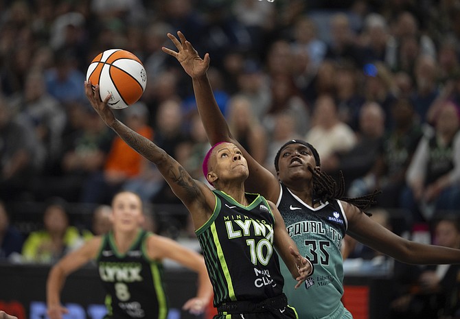 Minnesota Lynx guard Courtney Williams (10) shoots while trailed by New York Liberty center Jonquel Jones (35) in the second quarter in a WNBA basketball game Wednesday, July 30, 2025 in Minneapolis. (Jeff Wheeler/Star Tribune via AP)