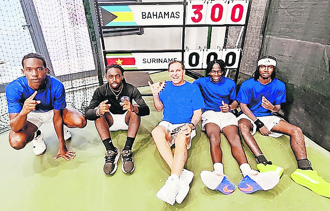 TOP: Davis Cuppers Michael Major Jr, Denali Nottage, captain John Antonas, Donte Armbrister and Kofi Bowe celebrate after their win over Suriname. ABOVE: Kofi Bowe and Donte Armbrister after their doubles victory over Suriname yesterday.