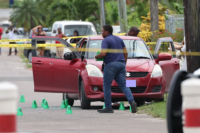 Bullet holes and shattered glass on a vehicle at the scene of a shooting where two men were killed and five more injured on Saturday afternoon. 
Photo: Dante Carrer/Tribune Staff