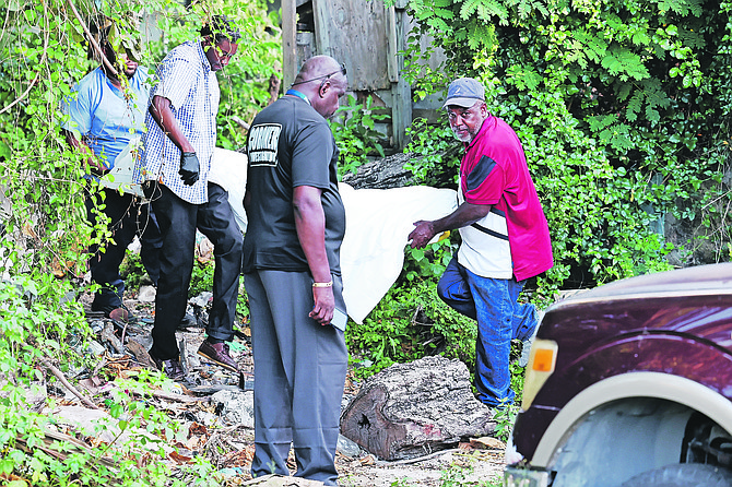 A body is taken from the scene of Wednesday’s shooting in Lexington Avenue. 
Photo: Dante Carrer/Tribune Staff