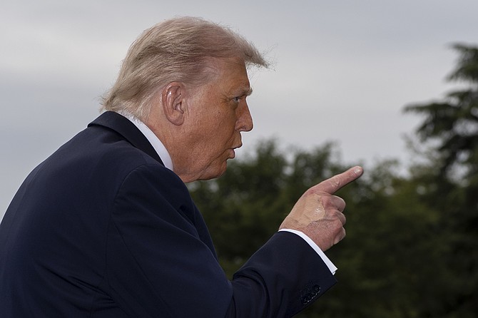President Donald Trump speaks with reporters before departing on Marine One from the South Lawn of the White House, Tuesday, Sept. 16, 2025, in Washington. (AP Photo/Alex Brandon)