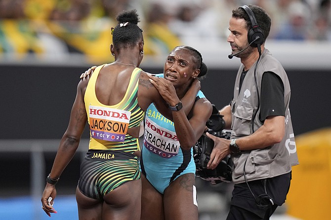 Bahamas' Anthonique Strachan, center, reacts after competing in women's 200 meters semifinal at the World Athletics Championships in Tokyo on September 18, 2025. (AP Photo/Eugene Hoshiko)