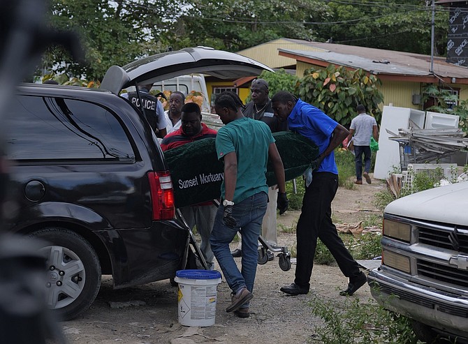 The body of a man being removed from where three persons were shot, with one succumbing to their injuries at the scene off Kemp Road, and another dying later at the hospital on September 23, 2025.
Photo: Chappell Whyms Jr