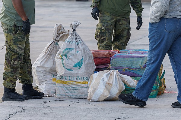 Members of a joint drug Taskforce unload suspected cocaine from an airplane at Odyssey Aviation on October 5, 2025. Photo: Dante Carrer/Tribune Staff