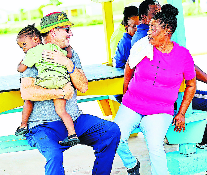 Robert Dupuch-Carron, founder of BACSWN, speaks with a resident on Crooked Island.