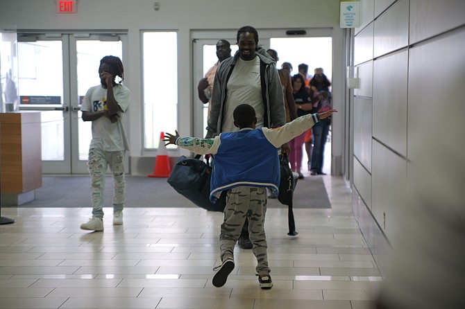 EVACUEE Daniel Johnson is welcomed by Mykea Johnson after arriving in New Providence from Acklins yesterday. Photo: Chappell Whyms Jr