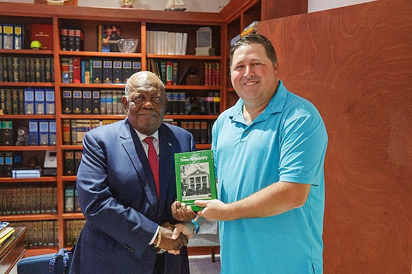 Author and FNM candidate for Central and South Abaco Jeremy Sweeting presents his book titled “The House of Assembly - The Journey of Bahamian Democracy” to Former Prime Minister Hubert Ingraham who wrote the foreword at Mr Ingraham’s office on November 7, 2025. Photo: Dante Carrer/Tribune Staff