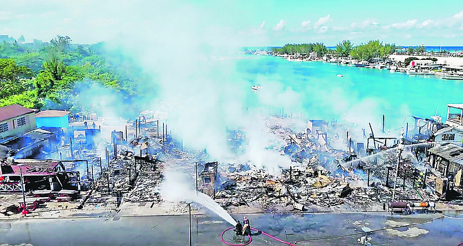 FIREFIGHTERS battle a massive fire at Arawak Cay’s Fish Fry on
November 16, 2025.