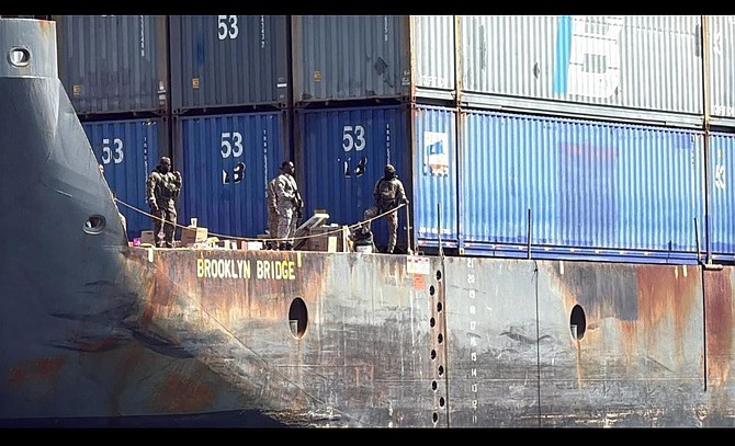 Royal Bahamas Defence Force officers stand guard aboard the container barge "The Brooklyn Bridge" on November 14, 2025.