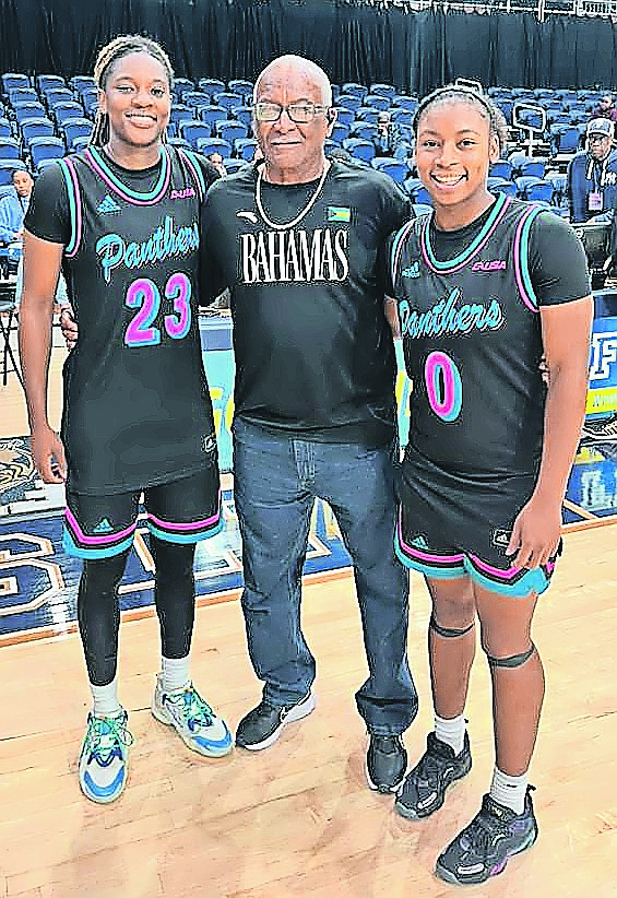 COACH Anthony Swaby, centre, shares a special moment with Rhema Collins, left, and Denika Lightbourne.