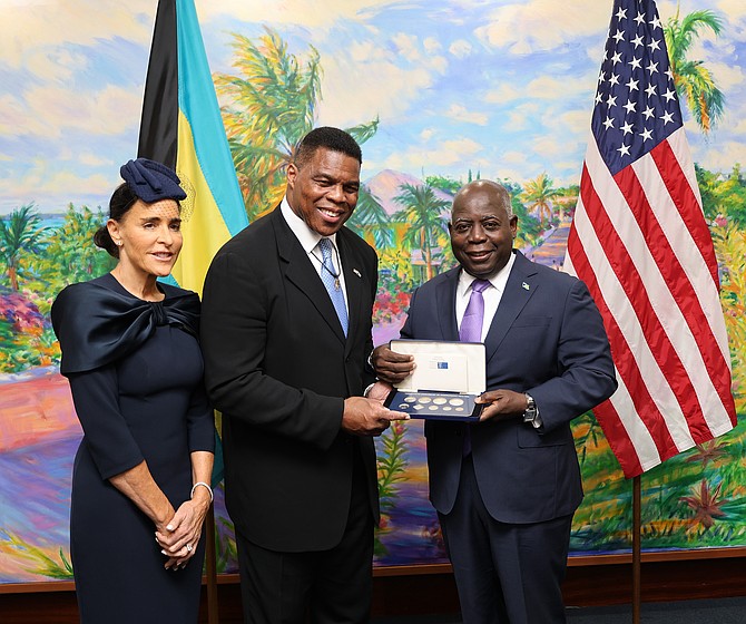 US Ambassador to The Bahamas Herschel Walker and his wife, Mrs. Julie Walker with Prime Minister Philip ‘Brave’ Davis during a courtesy call at the Office of the Prime Minister on December 9, 2025. (BIS Photos/Patrick Hanna)