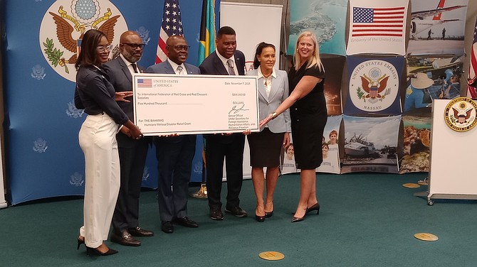 US AMBASSADOR Herschel Walker (third from right) presents a cheque for $500,000 to the Bahamas Red Cross, represent by its president Edison Sumner (second from left). Also attending are Deputy Prime Minister Chester Cooper (centre) the US Ambassador’s wife Julie Walker and US Deputy Chief of Mission, Kimberley Furnish (right).