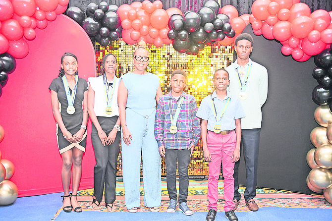 COACH Sherry Francis with members of the NACAC Age Group Championship team. Photo: Chappell Whyms Jr/Tribune staff