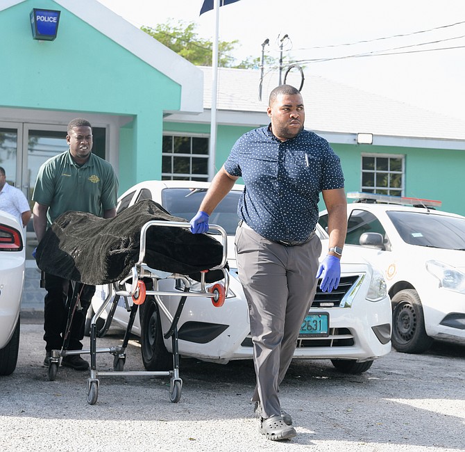 THE BODY of a man who died during an altercation while in police custody
is removed from Fox Hill Police Station yesterday. Photo: Shawn Hanna