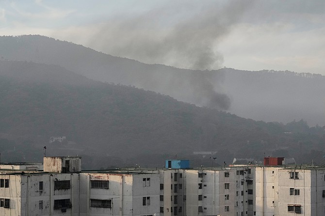 Smoke rises from Fort Tiuna, the main military garrison in Caracas, Venezuela, after multiple explosions were heard and aircraft swept through the area, Saturday, Jan. 3, 2026. (AP Photo/Matias Delacroix)