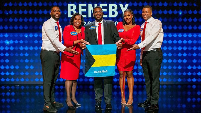 THE BENEBY family show off the Bahamian flag as they participated on the popular TV game show Family Feud (Canada).