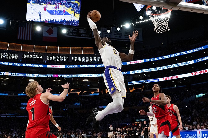 Los Angeles Lakers center Deandre Ayton (5) goes up for a basket during the first half of an NBA basketball game against the Toronto Raptors in Los Angeles, Sunday, Jan. 18, 2026. (AP Photo/Kyusung Gong)