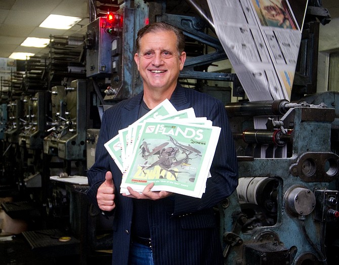 TRIBUNE President Robert Dupuch-Carron holds up copies of The Tribune’s new weekly section, Around da Islands. Photo: Chappell Whyms J