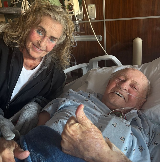 RUPERT Roberts smiles and gives the thumbs-up as he continues to recover in hospital with wife Margaret at his side.