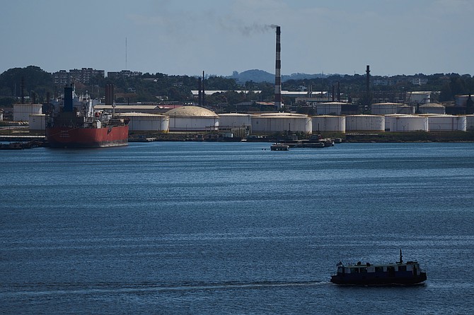 A ferry crosses Havana Bay past the Nico Lopez oil refinery where a Cuban tanker is anchored in Havana, Cuba, Thursday, Feb. 26, 2026. (AP Photo/Ramon Espinosa)