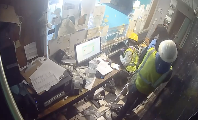 An armed gunman points a pistol at a woman's head in this video seen on social media.