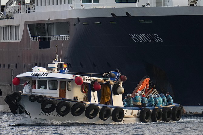 Passengers are disembarked from the hantavirus-stricken cruise ship MV Hondius at the port of Granadilla in Tenerife, Canary Islands, Spain, Sunday, May 10, 2026. (AP Photo/Manu Fernandez)