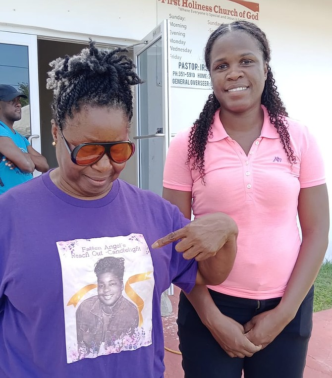 SHAVONNE Munnings points to a picture of her sister Tiffany Smith, who was killed 21 on years ago by her spouse, on her shirt.