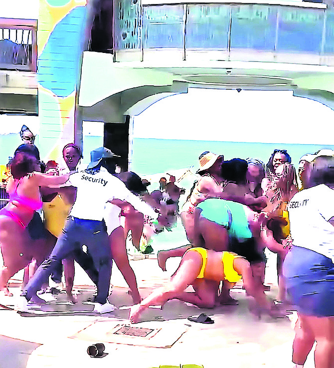 Security guards at Nassau Cruise Port try to separate brawling cruise passengers.