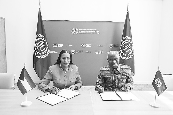 Labour and Public Service Minister Pia Glover-Rolle signs the country’s instruments of ratification to ILO Director-General Gilbert Houngbo at a recent ceremony.