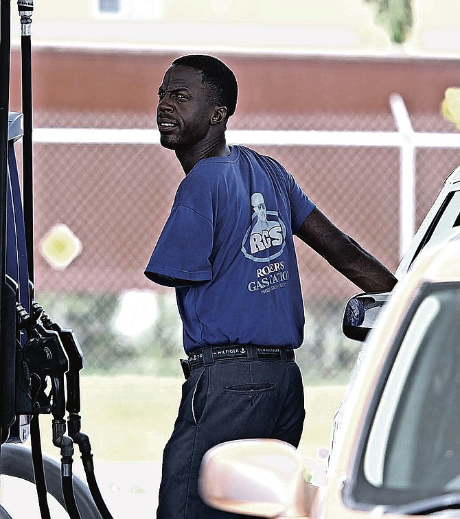 Francent Yoth, a man born with just one arm, pumps fuel at Roker's Gas Station on Faith Avenue. Photos: Chappell Whymns Jr.