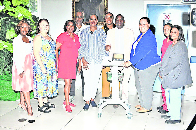 The Rotary Club of Grand Bahama and Coakley International donate a new electrocardiogram machine to Rand Memorial Hospital on Thursday.
 Photos: Vandyke Hepburn