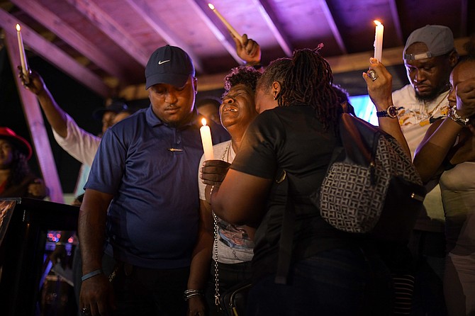 FAMILY members, friends and supporters gather at The Pond during a candlelight vigil on July 14, 2026 to honour the memory of the victims who lost their life in the Flamingo Air plane crash on Independence Day in Andros. Photo: Shawn Hanna