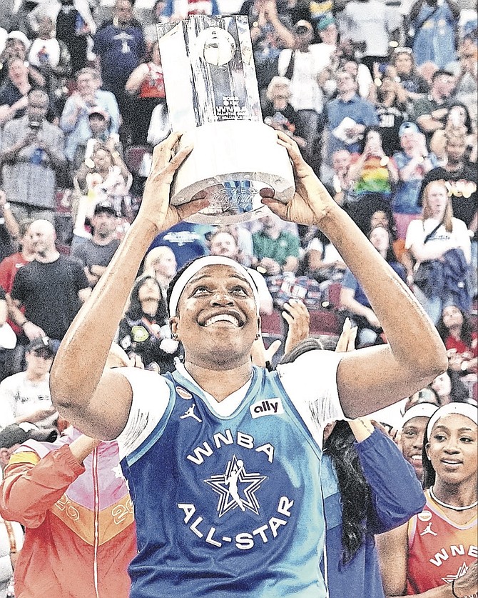 Most Valuable player: Team Spoon's Jonquel Jones smiles as she holds up the MVP trophy after Team Spoon defeated Team Cooper in a WNBA All-Star basketball game in Chicago, Saturday,July 25,2026. 
(AP Photo/Nam Y Huh)