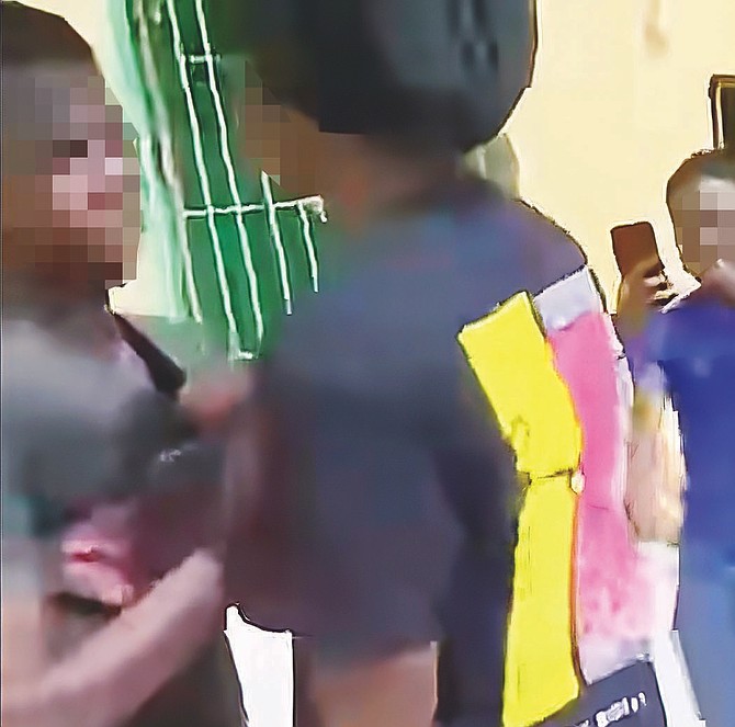 A still image from a video that went viral on social media shows
part of the alleged assault involving a 13-year-old student during
summer school at C H Reeves Junior High School.