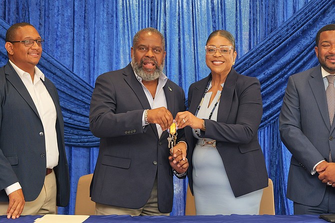 Doctor's Hospital President Dr Charles Diggis hands keys to PMH managing director Aubynette Rolle as PHA acquires Doctor’s Hospital’s Harborside facility for $29m. Photos: Nikia Charlton