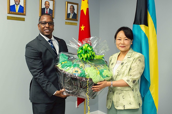 Chinese Ambassador to The Bahamas, Her Excellency Yan Jiarong (right) presents a gift to Bahamas Public Parks & Public Beaches Authority Executive Chairman Jamahl Strachan on August 6, 2026.