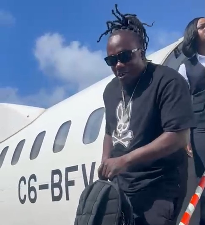 JADE Adderley gets off a Bahamaasair plane that landed safely after developing landing gear trouble.